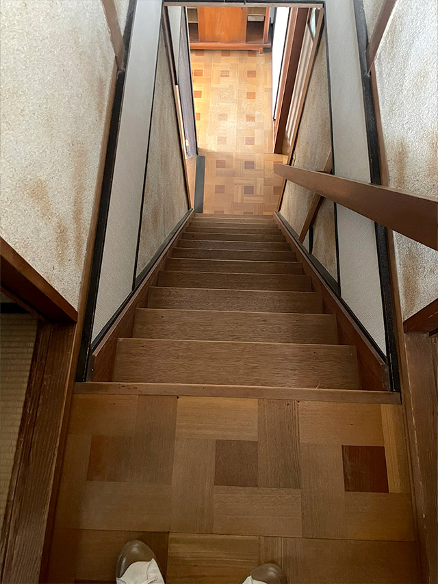 リノベーション前の木製階段の様子。細く急な段が続く昔ながらの造りを記録した写真